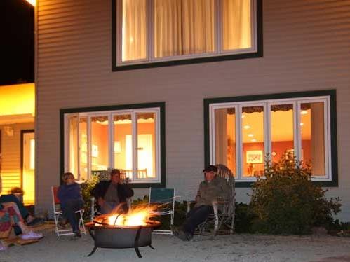 Guests gathered around a fire at Brookdale Country Inn